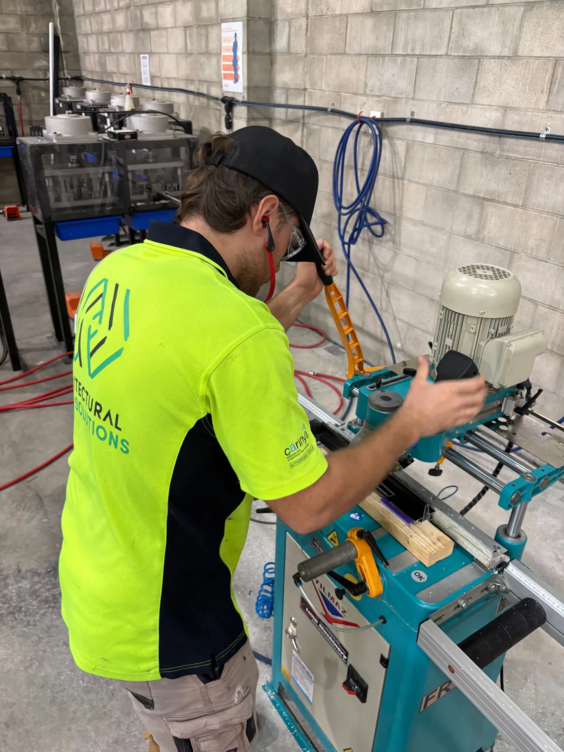 AGS fabricator machining an aluminium window frame in the Cooroy factory